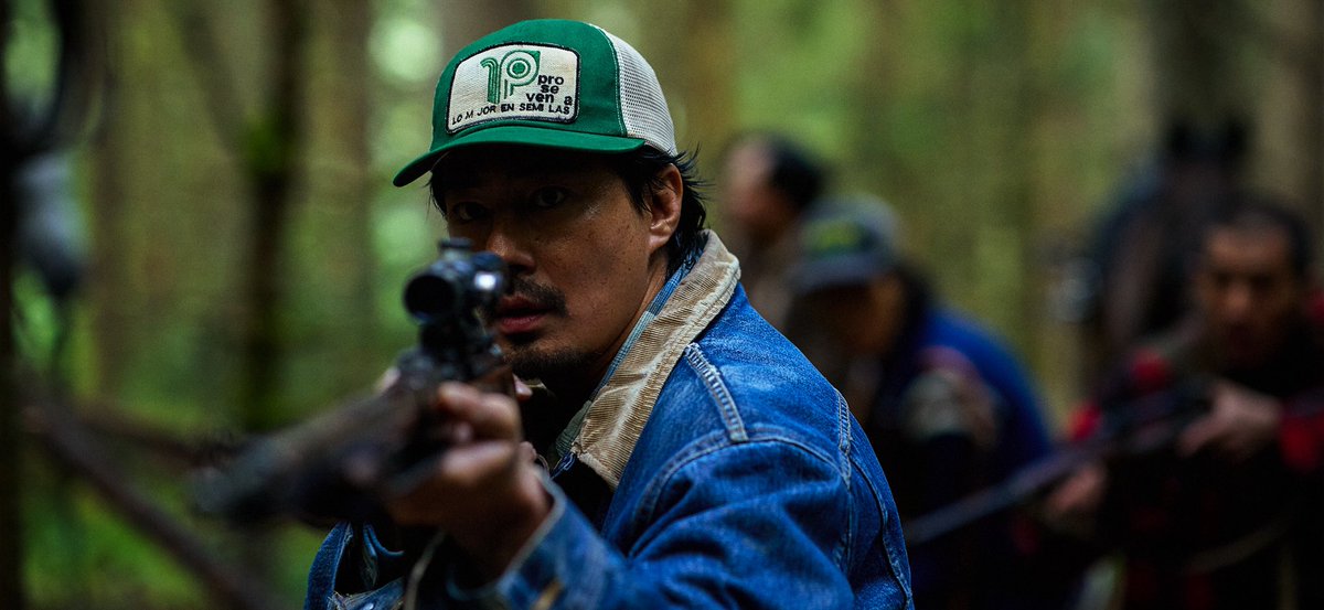 Sung-ki aims a rifle in the forest in Hope