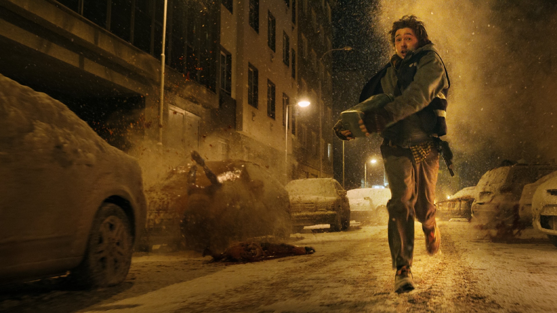 Austin Abrams runs through a snow-covered street in Resident Evil